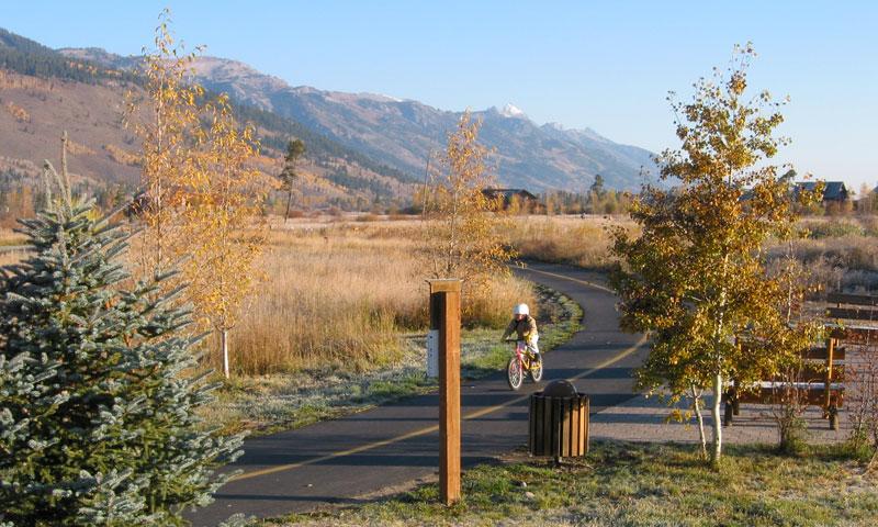 Kid riding bike along Jackson Paved Trail